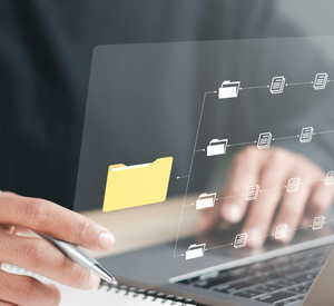 Mann sitzt vor Laptop und nutzt elektronische Akten